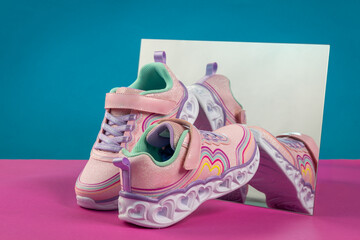 Stylish pink glitter sneakers for girls, featuring a colorful rainbow design. Playful Children?s Footwear, Fashion Product Display for Retail, Advertising and E-Commerce