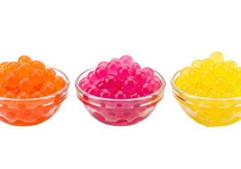Extreme macro close-up of three bowls containing vibrant orange, pink, and yellow hydrocolloid popping boba pearls on a transparent studio background, concept of molecular gastronomy