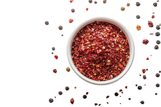 Vibrant red crushed chili flakes in white bowl essential hot spice for on transparent background