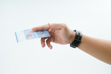 Hand holding Malaysian ringgit banknote on white background representing cash payment, personal...