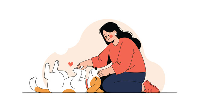 Kind young woman kneeling on the floor and gently petting a happy dog that is lying on its back in a playful and submissive pose.