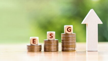Esg growth in sustainable finance, rising assets and coins on stacked levels, wooden blocks with letters esg and an up arrow, forward momentum and responsible investing trajectory ahead
