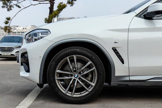 March 14, 2021, Seoul, South Korea - A white BMW X4 20i SUV parked outdoors, showing a close-up of the front wheel and fender.