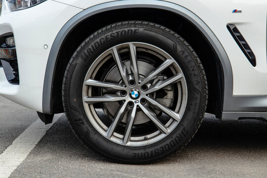 March 14, 2021, Seoul, South Korea - A close-up of the front wheel of a white BMW X4 20i car, showing the Bridgestone Alenza tire and alloy rim.