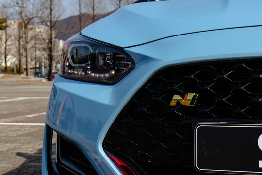 February 26, 2021, Seoul, South Korea - A close-up of the front grille and headlight of a light blue Hyundai Veloster N DCT performance car.
