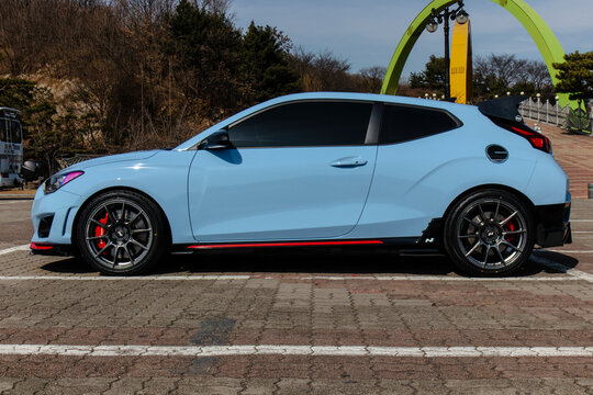 February 26, 2021, Seoul, South Korea - A light blue Hyundai Veloster N DCT performance hatchback parked in a lot.