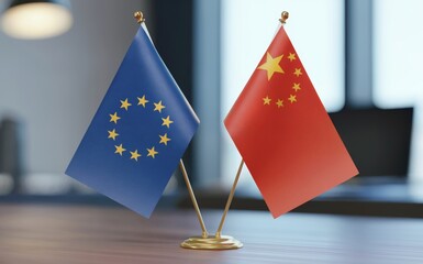 Small flags representing the European Union and China stand side by side on a polished wooden desk The indoor setting features soft lighting illuminating the blue and red fabrics This image conveys gl
