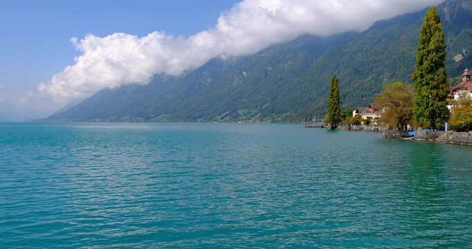 turquoise Lake Brienz and Brienz village under the Swiss Alps in Switzerland