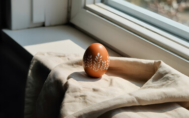 Happy easter sunday morning with decorative egg on windowsill
