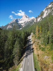 Mountain Road - Dolomites National Park Italy - Alpine landscape with mountains and pine trees in autumn fall summer - panoramic aerial view