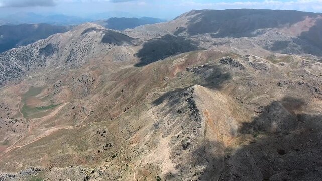 Aerial view of geography of Shiraz region in southern Iran. Rolling hills and dry valleys stretch into distance, revealing warm colors and the beauty of Persian landscape.