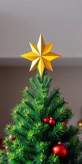 Golden star topper crowns a decorated evergreen tree, a bright symbol of Christmas cheer,  tree,  festive