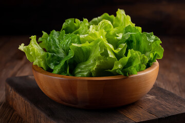 Lettuce in wooden bowl, 45 degree, on wooden background