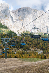 Alpine Summer Ski Chair Lift with mountains and trees in the background - dolomites Italy