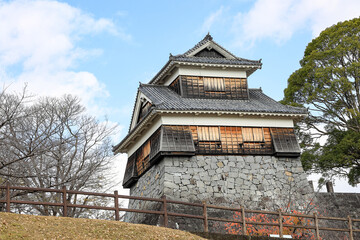 Naklejka premium The fortress or rampart standing high in ancient castel of japan, with blue sky.