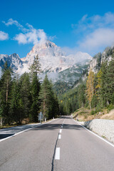 Mountain Road - Dolomites National Park Italy - Alpine landscape with mountains and pine trees in autumn fall summer - panoramic aerial view