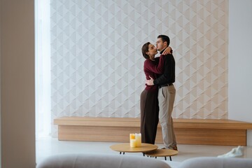 Couple dances together in a modern living room filled with intimacy