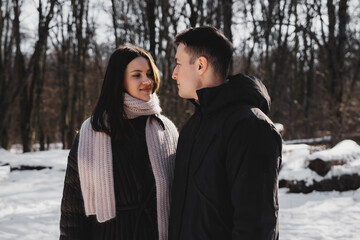 Couple enjoying winter day in a snowy forest setting