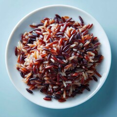Plate of cooked multi-colored wild rice against a light blue background