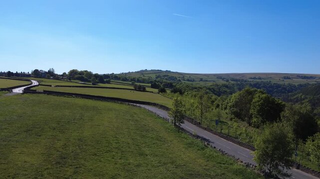 scenic aerial view of calderdale west yorkshire landscape near hebden bridge in summer showing a country lane running next to hardcastle crags valley in summer