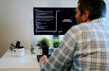 Older Office Worker AI Vibe Coding in Home Office