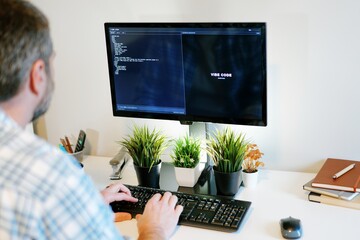 Older Office Worker AI Vibe Coding in Home Office