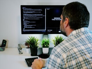 Older Office Worker AI Vibe Coding in Home Office