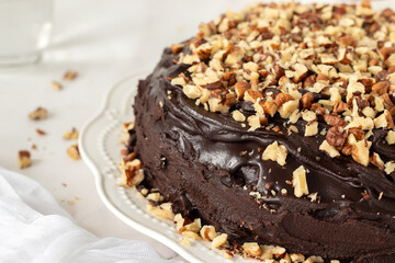 Chocolate walnut cake on a plate. Close-up. Selective focus. Delicious homemade dessert.
