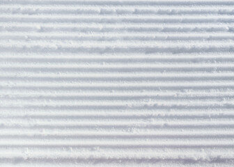 Prepared ski slope surface with new line patterns. Winter sports texture.