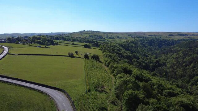 scenic aerial view of calderdale west yorkshire landscape near hebden bridge in summer showing a country lane running next to hardcastle crags valley in summer
