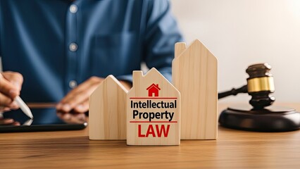 Intellectual property law concept with wooden house models and gavel