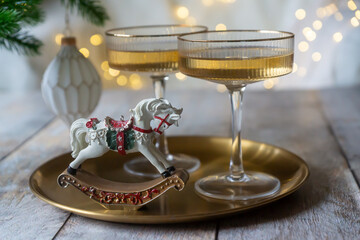 New Year 2026: champagne and Christmas tree decorations on the table.
