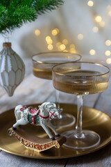 New Year 2026: champagne and Christmas tree decorations on the table.