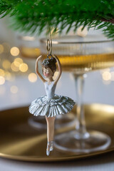 New Year 2026: champagne and Christmas tree decorations on the table.