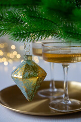 New Year 2026: champagne and Christmas tree decorations on the table.