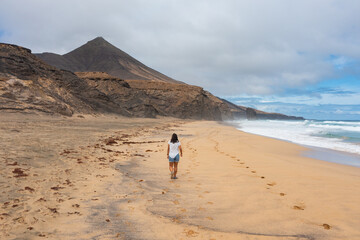 Aerial view of a woman walking on Cofete Beach, Fuerteventura, Canary Islands