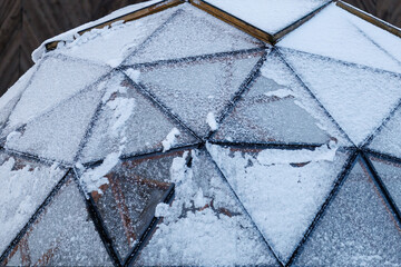Geodesic glass dome covered with snow in winter