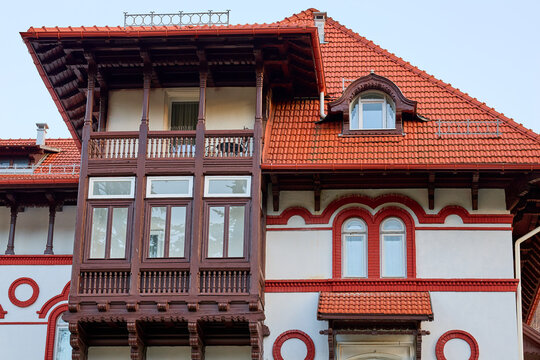 Historic european architecture with ornate red roof and wooden balconies
