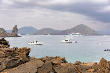 Tour operator boats in Sullivan Bay off the coast of Santiago and Bartolome Islands in The Galapagos