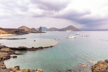 Tour operator boats in Sullivan Bay off the coast of Santiago and Bartolome Islands in The Galapagos