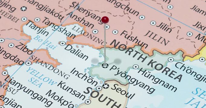 A zoom out of a red pin into pyongyang city of north korea political map