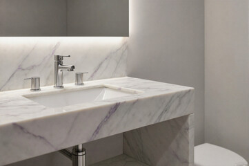 Modern bathroom vanity with white marble countertop and purple veining, stainless steel faucet, and under-cabinet lighting.