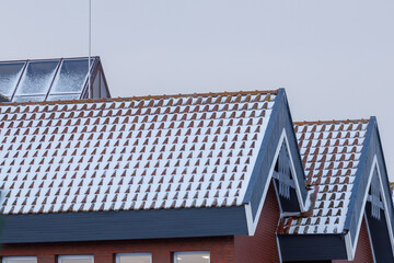 Snow covered tiled rooftops in winter