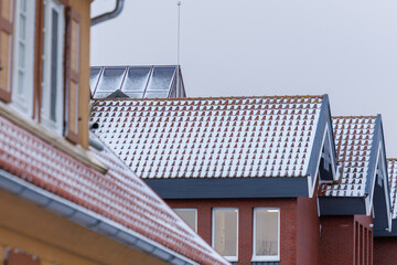 Snow covered tiled rooftops in winter
