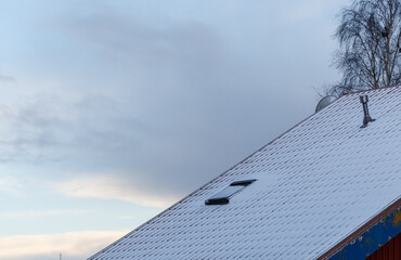 Snow covered tiled rooftops in winter