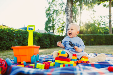 Playing joyfully with colorful building blocks in a sunny backyard during a delightful afternoon