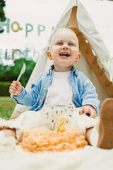 Celebrating a joyful birthday party for a young child in a serene outdoor setting with decorations and a delightful cake