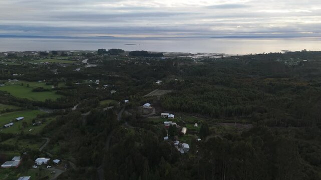 Aerial Spiral View of Village Valley and Coastal Bay