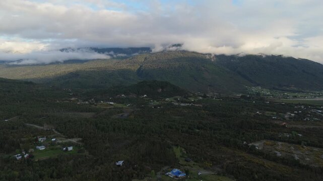 Panoramic Aerial View of Valley Village Houses and Clouded Mountains