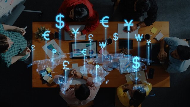 A dynamic scene of individuals collaborating at a table surrounded by technology, featuring digital currency symbols representing a global financial network. Raster - Powered by Adobe